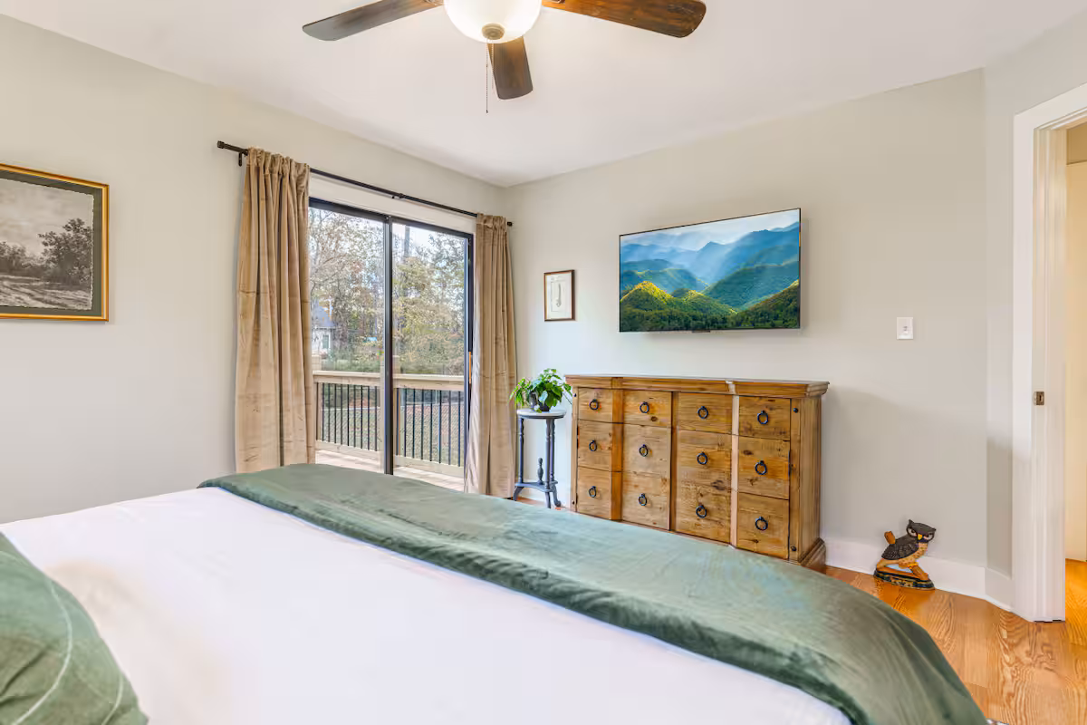 Private bedroom opening onto a wooded deck